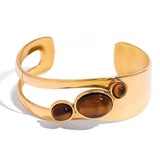 "Bracciale Vintage in Occhio di Tigre Dorato" can be rewritten as "Bracciale Vintage in Occhio di Tigre con Finitura Dorata".